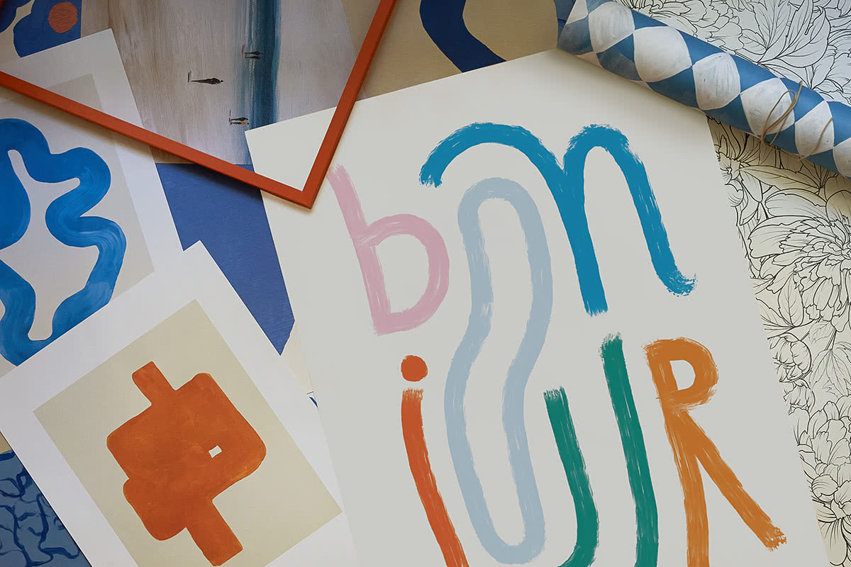 Affiches colorées, dont une affiche bon jour, étalées sur une table