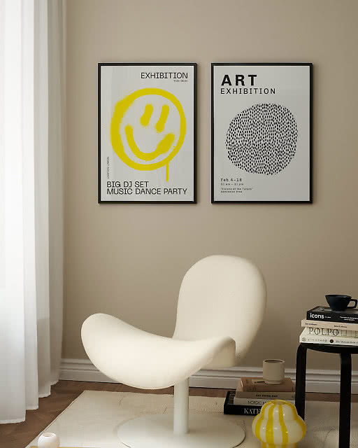 A yellow smiley face Exhibition print and an Art Exhibition dot circle print above a sculptural white lounge chair.