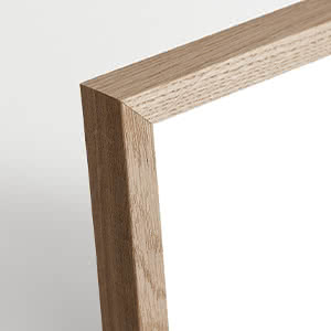 Close-up of a light wood frame corner against a light background