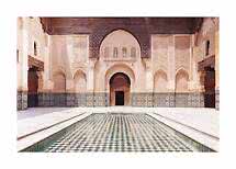 Courtyard with ornate arches, mosaic walls and a rectangular reflecting pool