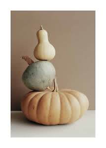 Three stacked pumpkins against a beige background