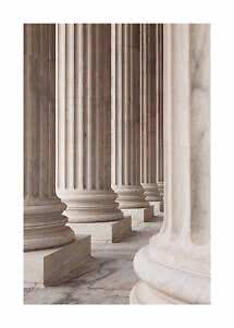 Row of fluted marble columns in light beige and gray tones