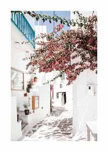 Narrow white alley with stone path, blue balcony, and pink bougainvillea in sunlight