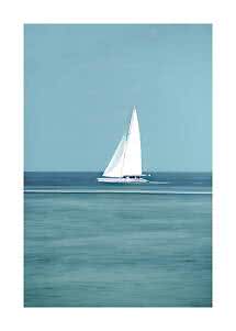 White sailboat on calm blue sea under a clear sky