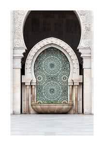 Ornate stone wall with arched niche, mosaic pattern, and Moorish-style fountain
