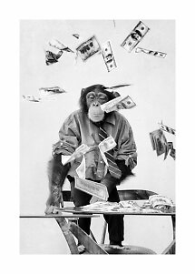 Black-and-white photo of a chimpanzee in a shirt and tie at a table with dollar bills flying around.