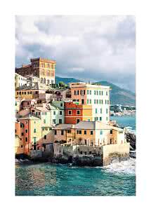 Colorful seaside houses on rocky shore with mountains and dramatic cloudy sky