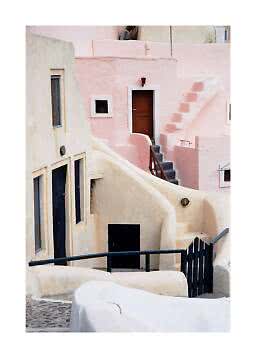 Pastel-colored houses with curved walls, stairs, and dark doors along a narrow alley