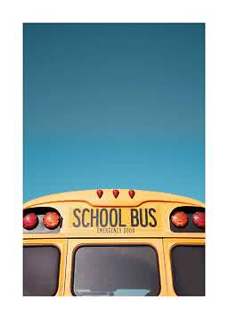 Top of a yellow school bus with rear lights against a clear blue sky