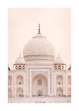 Front view of the Taj Mahal’s white marble dome and facade against a soft pink sky