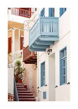 Narrow alley with white houses, blue balconies and windows, red steps, and potted plants