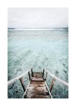 Wooden steps leading into clear turquoise sea with small waves under a cloudy sky