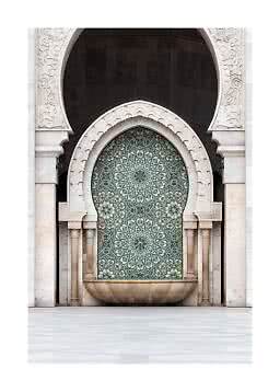 Ornate stone wall with arched niche, mosaic pattern, and Moorish-style fountain