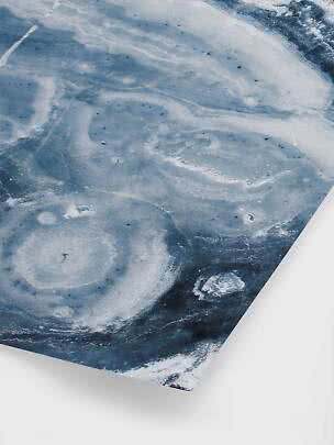 Close-up of paper with an abstract blue and white marbled pattern