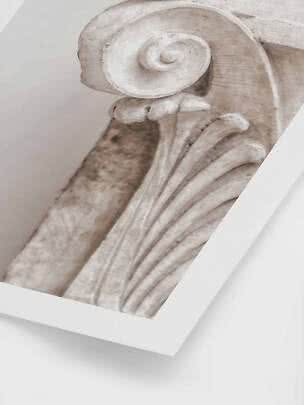Close-up of a classical column capital with spiral volute in beige tones