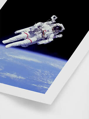 Framed photo of an astronaut floating in space above Earth’s curve