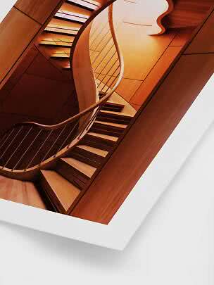 Curved wooden staircase with railing in a modern interior
