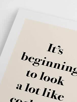 Close-up of a beige poster with black typography and text on a white background