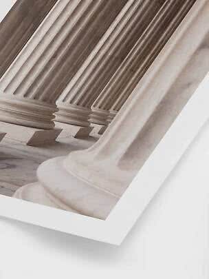 Close-up of classical marble columns in soft beige and gray tones