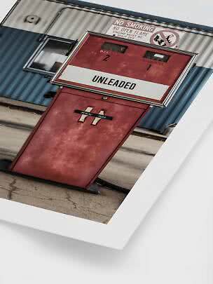 Red vintage gas pump with unleaded sign and no smoking warning