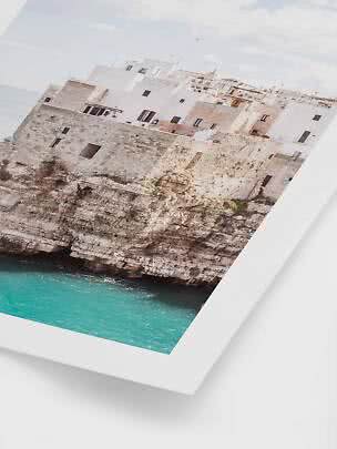 Framed photo of white cliffside houses above turquoise sea