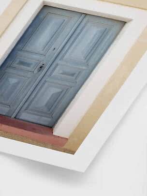 Light blue paneled double door set in a pale facade, viewed from below