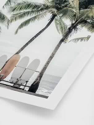 Wall art of palm trees and three surfboards by the beach