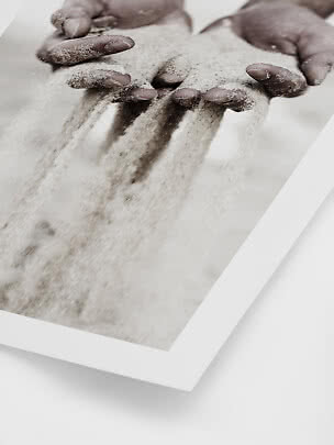 Close-up of hands letting fine sand run through the fingers