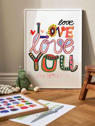 Framed typography poster with colorful "Love love you" text in a children's room