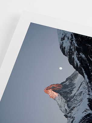 Gerahmtes Foto schneebedeckter Berge in der Dämmerung mit Mond am Himmel