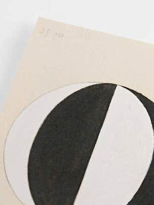 Close-up of abstract art print with black and white curved shapes on a cream background