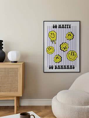 Framed poster with yellow smiley faces and the text "SO HAPPY SO BANANAS" on a striped background
