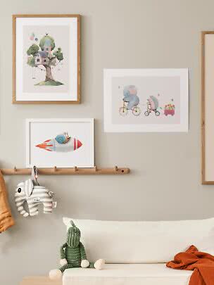 Children's room with framed animal and fantasy prints above a bench with soft toys