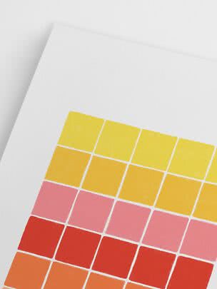Close-up of a diagonal color swatch card with yellow, orange, pink and red squares on white