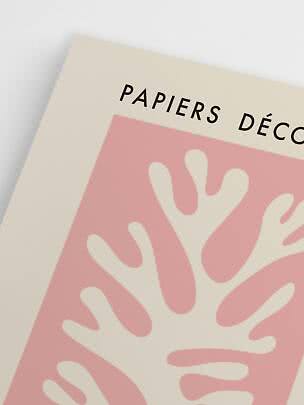 Close-up of art poster with "Papiers Déco" text and pink abstract leaf pattern