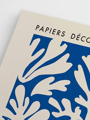 Close-up of cream art poster with blue abstract illustration and black text at the top