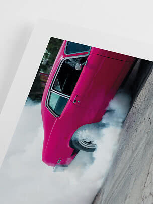 Leuchtend pinkes Klassikauto macht einen Burnout mit dichtem Rauch am Hinterrad