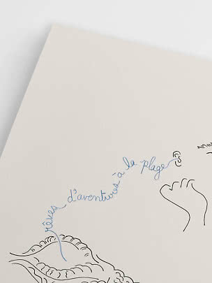 Close-up of cream-colored print with blue handwritten text and simple black line drawings