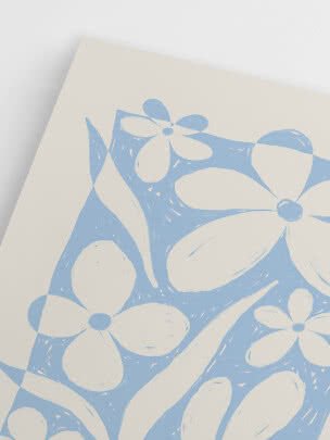 Close-up of white fabric or paper with a light blue floral print