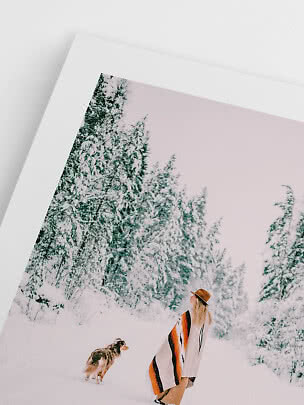 Photo encadrée d’une femme et d’un chien dans une forêt enneigée