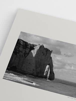 Black-and-white art print of coastal cliffs with a natural sea arch