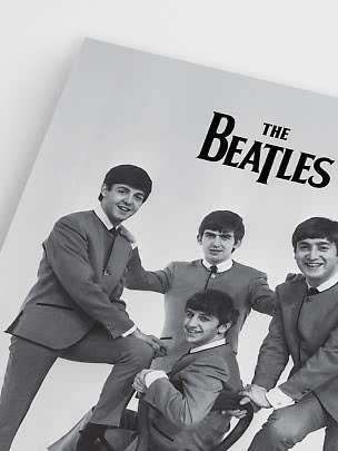 Black-and-white poster of The Beatles with four members in matching suits.