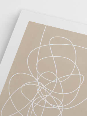Close-up of beige poster with white abstract line art and white border