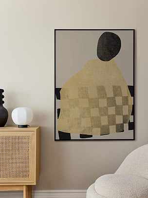 Abstract poster with black, beige and checkered shapes in a black frame on the wall