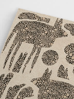 Angled close-up of the unframed print showing the crowded pebble fill, the interlocking shapes and the sand ground