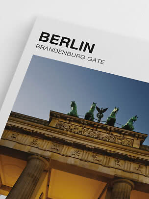 Poster reading Berlin Brandenburg Gate with a low-angle photo of the Brandenburg Gate