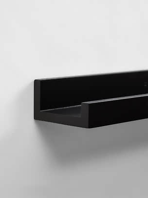 Schwarzes Wandregal aus Metall mit minimalistischem Design an weißer Wand