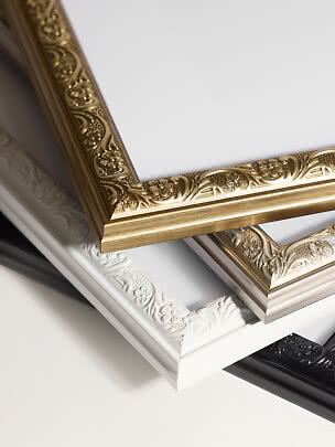 Close-up of Versailles picture frames with floral ornament detail in black, white, gold and silver