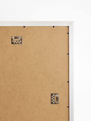 Back of white picture frame with MDF backing board and metal hangers