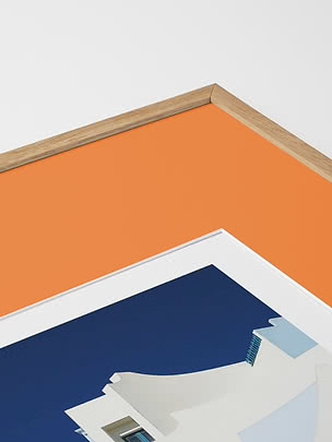 Primo piano in diagonale dello smusso di un passepartout in arancione dentro una cornice in rovere, con un poster blu sotto vetro